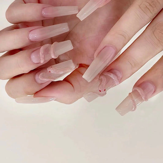 Serpent’s Whisper avant-garde press-on nails feature a bold, sculptural design that merges elegance with a surreal edge