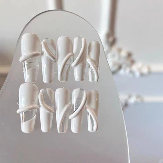Porcelain Swirl Elegance set of 10 press-on nails showcasing a sophisticated blend of matte white and clear acrylic, designed in a modern square-oval shape