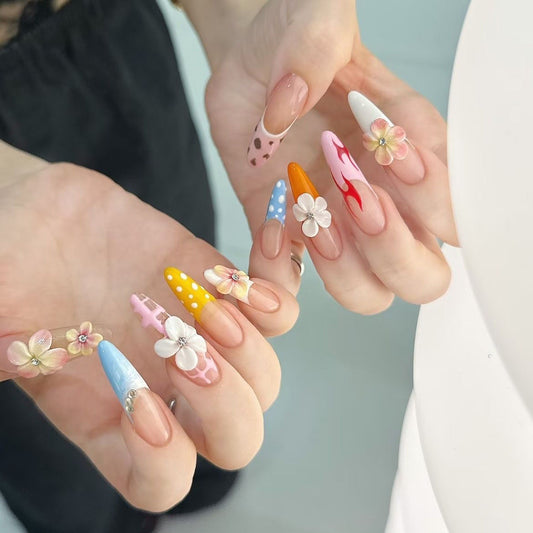 Whimsical Floral Carnival Nails long, stiletto-shaped press-on nails that burst with playful, vibrant charm. Each nail is a unique work of art, featuring a mix of designs