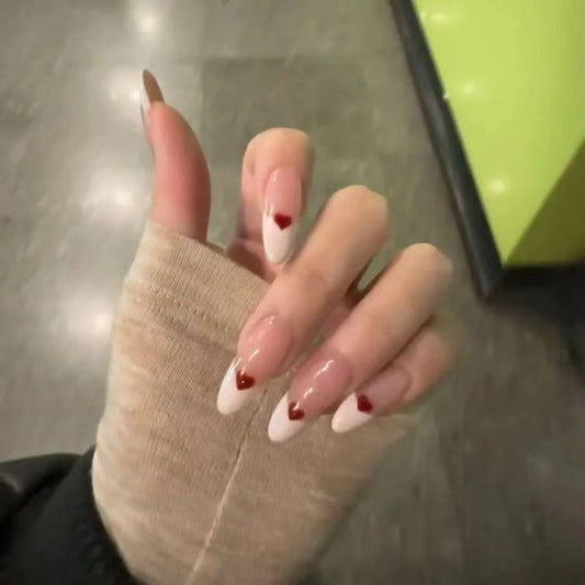 Blush Heart Tips set of natural-shaped press-on nails featuring an elegant gradient design. The nails transition from sheer nude-pink at the cuticles to crisp white at the tips