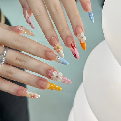 Whimsical Floral Carnival Nails long, stiletto-shaped press-on nails that burst with playful, vibrant charm. Each nail is a unique work of art, featuring a mix of designs