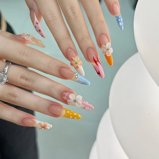 Whimsical Floral Carnival Nails long, stiletto-shaped press-on nails that burst with playful, vibrant charm. Each nail is a unique work of art, featuring a mix of designs