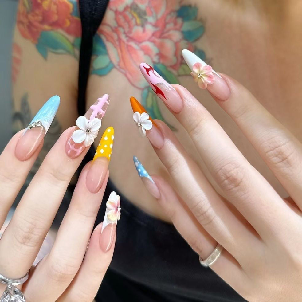 Whimsical Floral Carnival Nails long, stiletto-shaped press-on nails that burst with playful, vibrant charm. Each nail is a unique work of art, featuring a mix of designs
