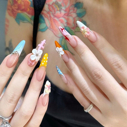 Whimsical Floral Carnival Nails long, stiletto-shaped press-on nails that burst with playful, vibrant charm. Each nail is a unique work of art, featuring a mix of designs