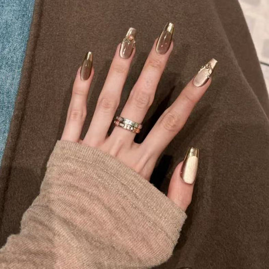 Mocha Gold Foil Tips set of almond-shaped press-on nails featuring a warm taupe-brown base with a smooth, creamy finish