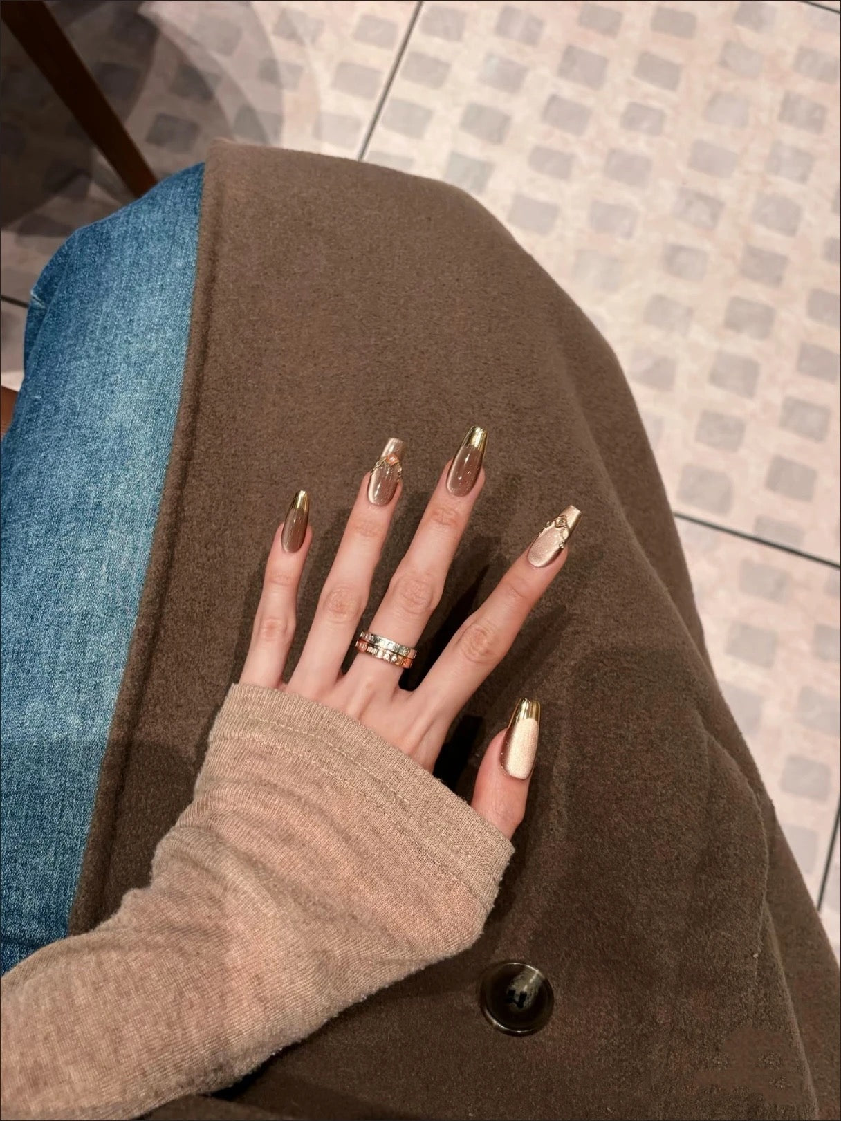 Mocha Gold Foil Tips set of almond-shaped press-on nails featuring a warm taupe-brown base with a smooth, creamy finish