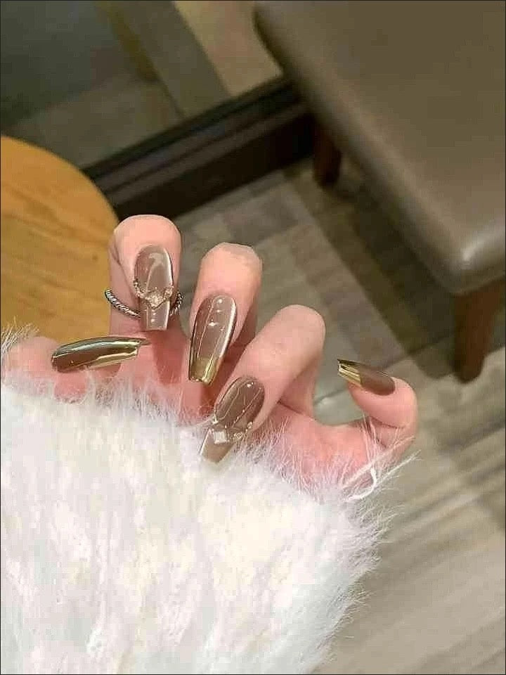 Mocha Gold Foil Tips set of almond-shaped press-on nails featuring a warm taupe-brown base with a smooth, creamy finish